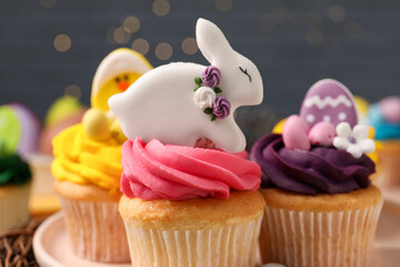 Tasty decorated Easter cupcakes on table, closeup