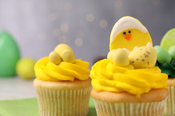 Tasty cupcakes with Easter decor on table, closeup