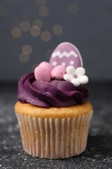 Gordijnen Tasty decorated Easter cupcake on grey table, closeup © New Africa