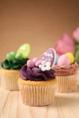 Poster Tasty cupcakes with Easter decor on wooden table © New Africa