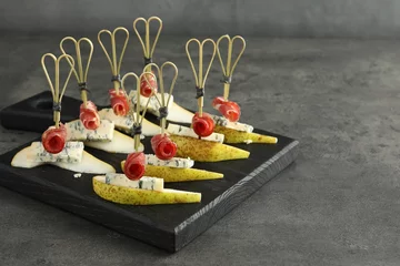 Outdoor kussens Tasty canapes with pears, blue cheese and prosciutto on grey table, closeup. Space for text © New Africa