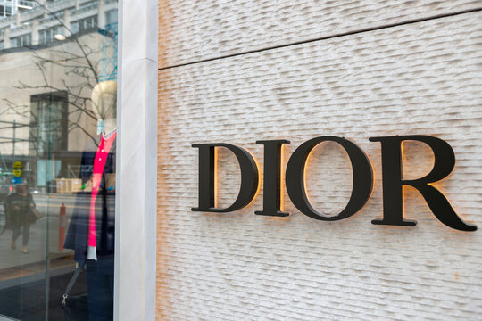 exterior building facade display window and sign of DIOR Toronto Colonnade, a clothing store, located at 131 Bloor Street West