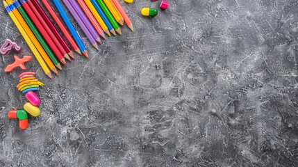 A black and white background with a row of colorful pencils and a bunch of candy - obrazy, fototapety, plakaty
