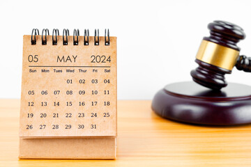 Desk calendar for May 2024 and judge's gavel.