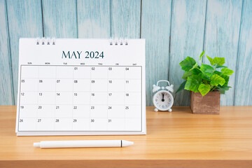 May Monthly desk calendar for 2024 year and alarm clock.