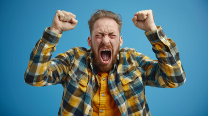 A man with a beard and a plaid shirt is yelling and raising his hands in the air