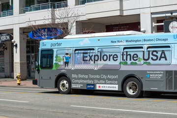 Fototapeta premium shuttle bus with Porter Airlines advertising on the road in downtown Toronto, Canada