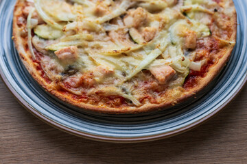 Italian homemade pizza with salmon and onions and parmesan, Italian cooking