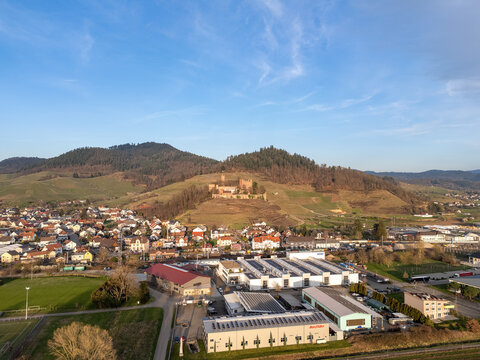 Ortenberg commercial area with Ortenberg Castle in spring at sunset, drone shot