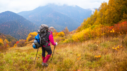 Fototapeta premium Person Hiking in the Autumn Mountains