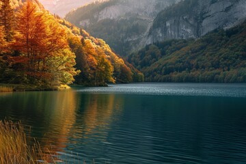Autumn landscape of a mountain lake, yellow trees and mountainside. The concept for the development of tourism, mountaineering, skiing, rock climbing, excursions in the mountains.  

