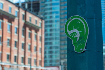 Fototapeta premium ghost green ear sign (part of [murmur] project) in downtown Toronto, Canada