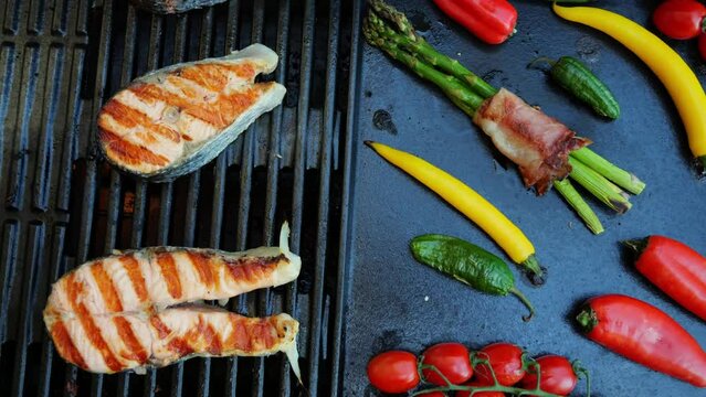 Salmon steak with vegetables on the cast iron grill barbecue. Seafood. Salmon grilled. Top view