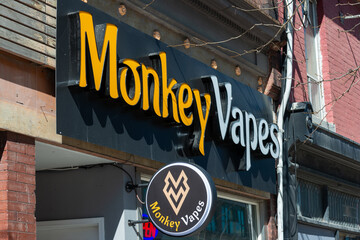 Fototapeta premium exterior building and sign of Monkey Vapes, a vaporizer store, located at 1194 Queen Street West in Toronto, Canada