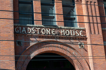 Fototapeta premium stone sign on facade of Gladstone House, a three-star hotel, located at 1214 Queen Street West in Toronto, Canada