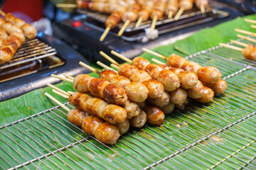 Pork and rice sausage or fermented hot dog northeastern isan thai style hanging in hawker stall for sale