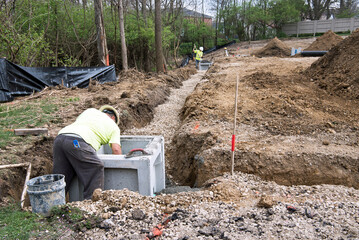Workers Cementing Corner Catch Basins in Place
