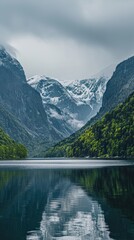 A majestic body of water sits nestled in a valley, surrounded by towering mountains. The calm water reflects the rugged peaks, creating a stunning natural landscape.