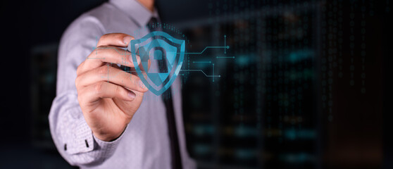 cybersecurity concept. businessman touches shield icon with padlock to protect important information