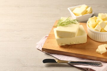 Tasty butter with dill and knife on wooden table. Space for text