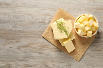 Tasty butter with dill on wooden table, top view. Space for text