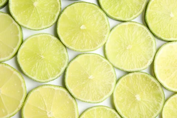 Foto op Plexiglas Fresh juicy lime slices on white background, flat lay © New Africa