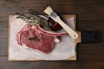 Raw meat, thyme and marinade on wooden table, top view