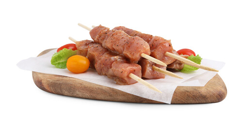 Wooden skewers with cut raw marinated meat isolated on white
