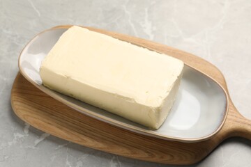 Block of tasty butter on grey table