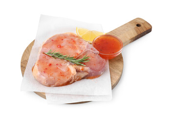 Board with raw meat, marinade, lemon and rosemary isolated on white
