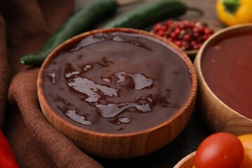 Homemade marinade in bowl on wooden table, closeup