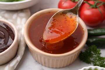 Taking homemade marinade from bowl at table, closeup