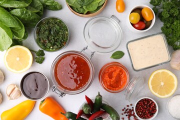 Different marinades and products on light table, flat lay