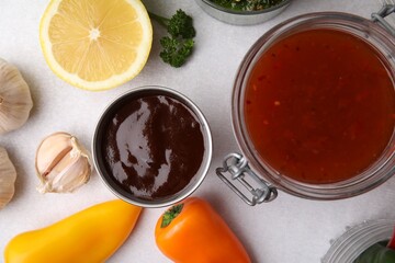Different marinades and products on light table, flat lay