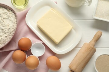 Flat lay composition with fresh butter and other products on white wooden table