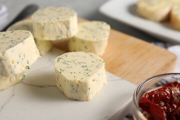 Tasty butter with dill and chili pepper on table, closeup