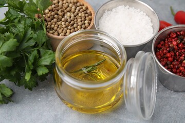 Aromatic peppercorns and different fresh ingredients for marinade on grey table, closeup