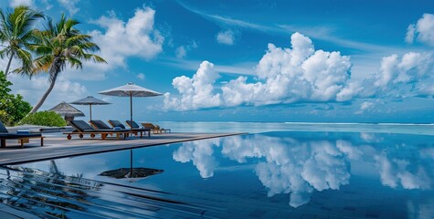 A relaxing getaway: an infinity pool overlooking the serene ocean, framed by lush palm trees and blue skies