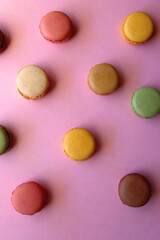 Obraz na płótnie Canvas Colorful macarons on pink background. Top view.
