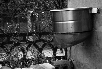 A water tank for a hand washer in the yard of a private house on the background of a house, color...