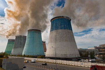 Huge cooling towers or chimneys emitting greenhouse gases from a coal fired power plant in Moscow,...