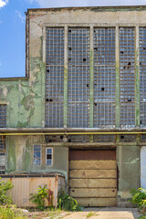 Closed Door Broken Windows at Old Abandoned Factory Building Exterior