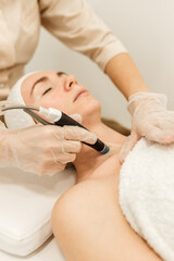 Elos epilation hair removal procedure on a woman’s body. Beautician doing laser rejuvenation in a...