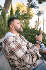 man checking mobile phone outdoors