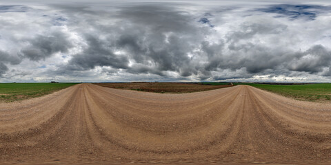hdri 360 panorama on wet gravel road among fields in spring nasty day with storm clouds in equirectangular full seamless spherical projection, for VR AR virtual reality content - 783190816