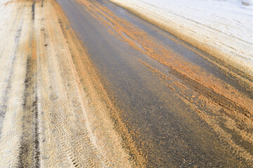 Rural winter road sprinkled with sand against ice