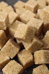 Brown sugar cubes on table, closeup view