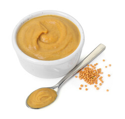 Fresh tasty mustard sauce in bowl and spoon with dry seeds isolated on white