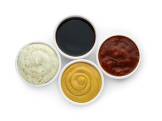 Many different sauces in bowls on white background, top view