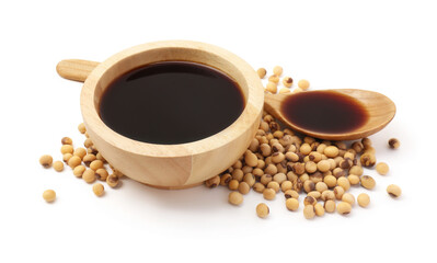 Tasty soy sauce in bowl, soybeans and spoon isolated on white